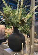 Grote zwarte design vaas van 60 cm met bloemen in modern interieur